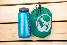 extra small ultralight dog sleeping bag in stuff sack next to nalgene water bottle